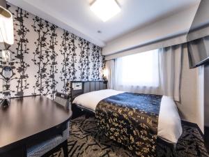 מיטה או מיטות בחדר ב-APA Hotel Shinagawa Togoshi Ekimae