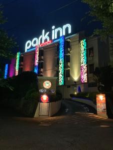 a building with a lot of neon signs on it at Hotel Park Inn (Adult Only) in Higashimatsuyama