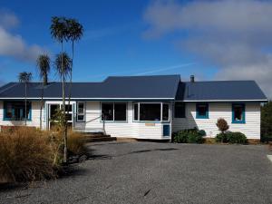 a white house with a black roof at Riversong Retreat in Ohakune