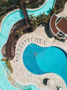 an overhead view of a swimming pool at a resort at Oka Beach Residence- 104D Térreo in Porto De Galinhas