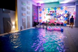 a pool at a party with a party room at The Vrindwoods in Vrindāvan