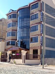 a building with a sign on the side of it at Villa Grazia Luxury Hotel in Naivasha