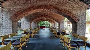 an archway in a brick building with tables and chairs at Anandvan Holiday Homes, Wai in Wai