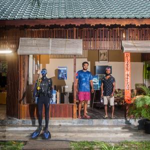 a group of three men standing outside of a building at Sea Shell Resort & Spa, Havelock in Havelock Island