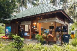 a small building with a store in a forest at Sea Shell Resort & Spa, Havelock in Havelock Island