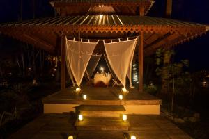 a gazebo with a white canopy with lights at Sea Shell Resort & Spa, Havelock in Havelock Island