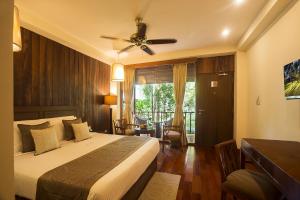 a bedroom with a bed with a ceiling fan at Sea Shell Resort & Spa, Havelock in Havelock Island
