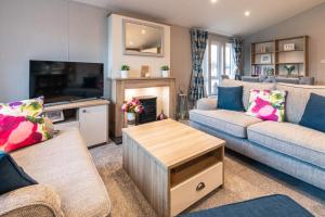 A seating area at The Haven Lodge with Hot Tub