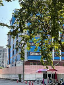 wysoki niebieski budynek z budynkiem w obiekcie Rest@Ratchada hotel w mieście Bangkok