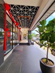 a building with a potted plant and red bows at Sovotel @ USJ 9 in Subang Jaya