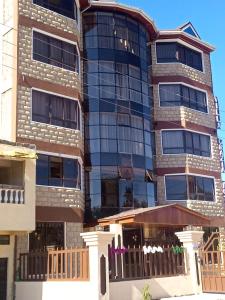 a tall building with a fence in front of it at Villa Grazia Luxury Hotel in Naivasha