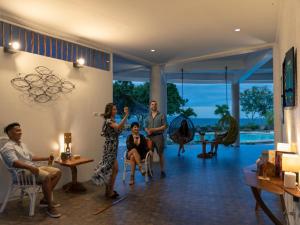 a group of people sitting in a living room at Granada Beach Resort - Adults Only in Boljoon