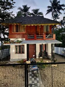a house with a fence in front of it at Cherai Beach Retreat in Cherai Beach