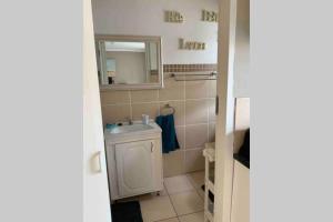 un bagno con lavandino e specchio di Cozy guest suite with private access a Roodepoort
