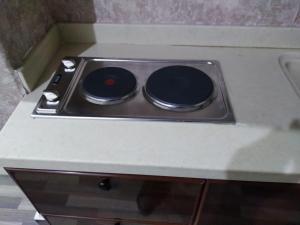 a stove top with two burners on a counter at Iwaa Alkharj Apartments in Al Kharj