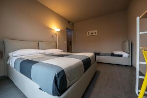 a hotel room with a bed and a lamp at Dannunziano Aparthotel in Chieti