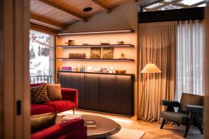 a living room with a red couch and a table at Arla Luxury Home in Lech am Arlberg +25 photos