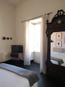 Postel nebo postele na pokoji v ubytování Palazzo Melfi