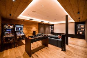 a video game room with several pinball machines at Arla Luxury Home in Lech am Arlberg