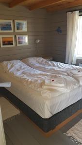 a large white bed in a room at Lofotbo in Stamsund