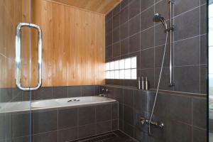 a bathroom with a shower and a bath tub at Ginsetsu in Kutchan +23 photos