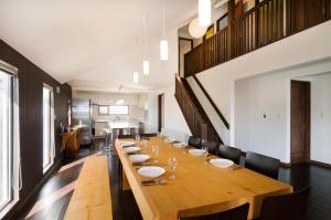 a large dining room with a long wooden table at Sugarpot in Kutchan
