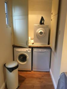 a laundry room with a washing machine and a washer at Countryside townhouse in Shireoaks +4 photos