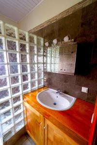 ein Bad mit einem Waschbecken und einem Spiegel in der Unterkunft Villa Belle Vue in Kigali