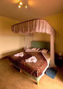 a bedroom with a bed with a canopy at Villa Belle Vue in Kigali