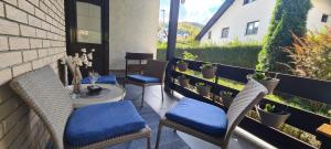 a patio with chairs and a table on a balcony at Ušuškani Studio in Zlatibor