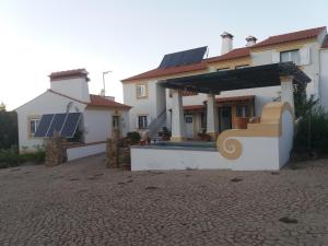 a house with solar panels on the roof at Eira Velha in Portalegre