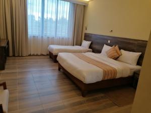 Ένα ή περισσότερα κρεβάτια σε δωμάτιο στο The Willis Hotel, Bomet