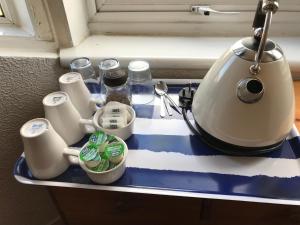 a kitchen counter with a tea kettle on it at Glades House in Glasgow