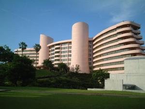 a large building with smoke stacks in front of it at Ibusuki Iwasaki Hotel in Ibusuki