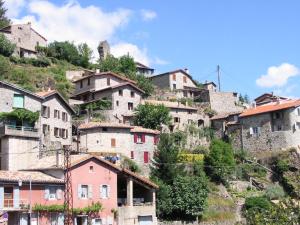 a group of houses on a hill with trees at la maison de laligier in Jaujac