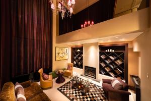 a living room with a couch and a wine cellar at Phoenix Hotel by Hakuba Hospitality Group in Hakuba