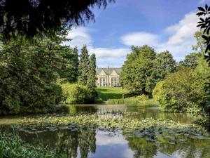 a large house with a pond in front of it at Mercure Sheffield Kenwood Hall & Spa in Sheffield