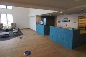 a lobby of a hospital with a reception desk and chairs at Days Inn by Wyndham Johnson Creek in Johnson Creek