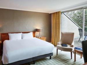 a hotel room with a bed and a balcony at Mercure Sheffield Kenwood Hall & Spa in Sheffield