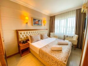 Postel nebo postele na pokoji v ubytování Mekke Hotel Istanbul