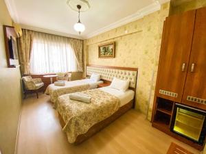 Postel nebo postele na pokoji v ubytování Mekke Hotel Istanbul