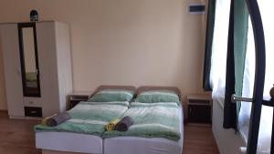 A bed or beds in a room at Bajusz Vendégház