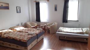 A bed or beds in a room at Bajusz Vendégház