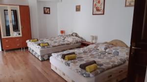 A bed or beds in a room at Bajusz Vendégház