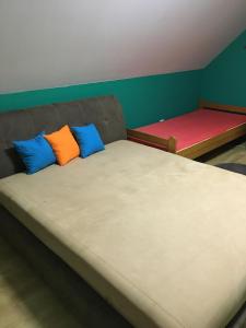 A bed or beds in a room at Centrum Vendégház