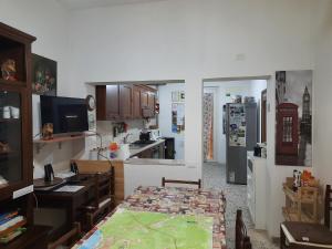 a kitchen with a refrigerator and a table in it at B&B Falcone in Ortona