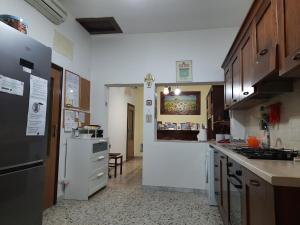 a kitchen with white cabinets and a counter top at B&B Falcone in Ortona