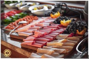 a table with many different types of cheese and fruit at Bilitom Hotel in Baghdād