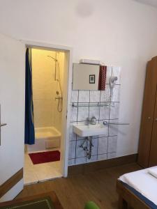 a bathroom with a sink and a shower and a tub at Hotel Pension Schmellergarten in Munich +37 photos