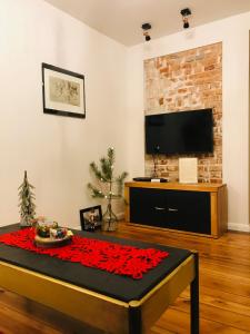 a living room with a table with red roses on it at Mrongowiusza 3 in Olsztynek